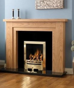 Gold style gas fire set in wooden surround against blue wall