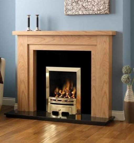 Gold style gas fire set in wooden surround against blue wall