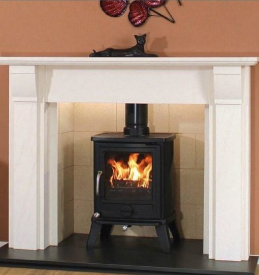 Wood burning stove in tiled fireplace with white surround