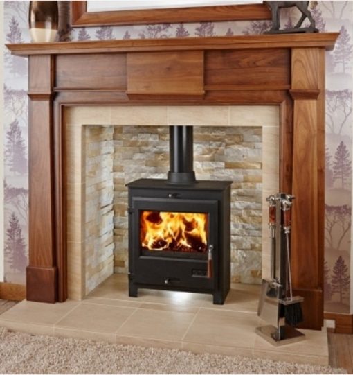 wood burning stove in pale brick fireplace with wooden surround