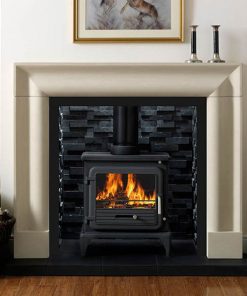 Wood burning stove in black brick fireplace