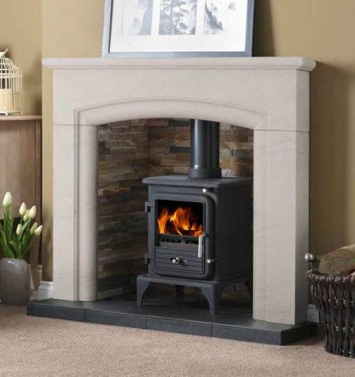 Wood burning stove in brick lined fireplace with marble mantel