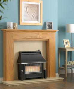 Older style black fire sits in wooden surround