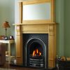 Traditional style surround and mirror over arched fireplace