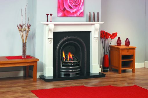 Arched cast iron fireplace in white veneered surround with ornate detailing