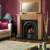 Cast iron arched fireplace set in solid oak surround with mirror