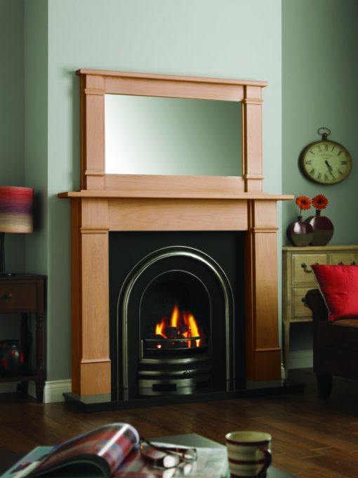 Classic arched fireplace mounted in timber surround with traditional detailing