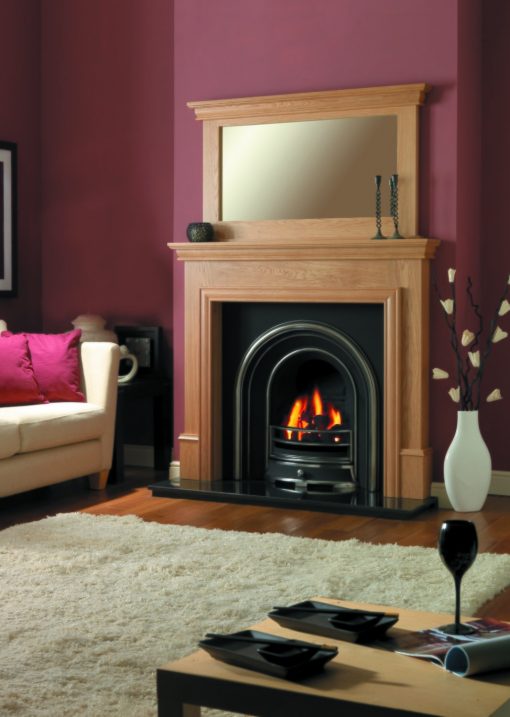 Arched fireplace with timber surround including mirror